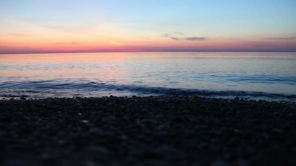 Waves during beautiful and colorful sunset / sunrise and horizon