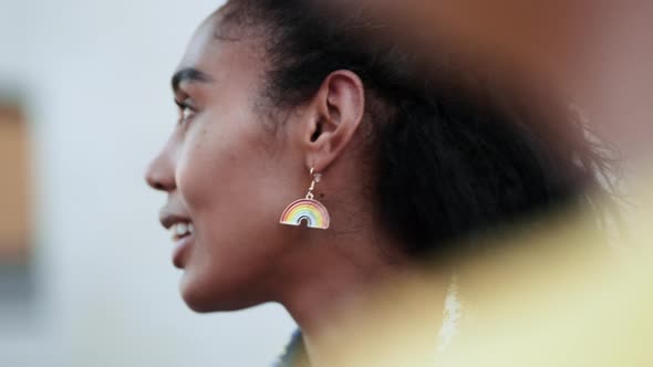 A close-up view of a smiling activist afro-american woman enjoying march on street for lgbt rights