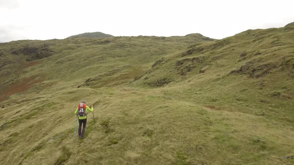 Hiker aerial view hiking in the hills