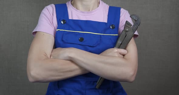 Female worker with a wrench. 