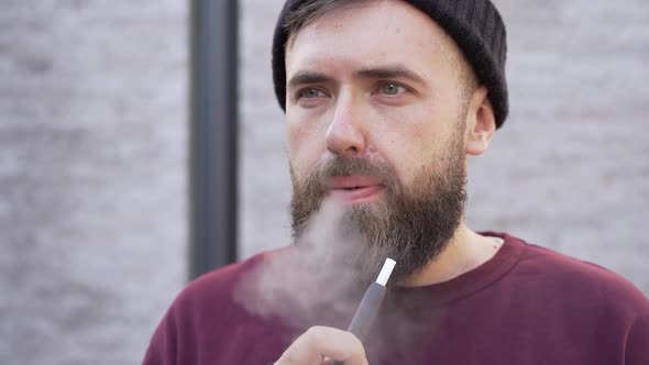 Close-up, a man smokes a cigarette