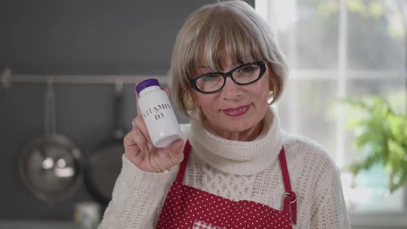 Beautiful Senior Woman Advertising Vitamins Smiling Looking at Camera Standing Indoors