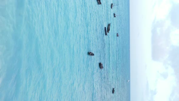 Vertical Video Boats in the Ocean Near the Coast of Zanzibar Tanzania Aerial View