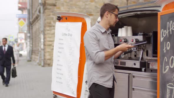 Idle Caucasian Barista Standing by Mobile Coffee Van in Street