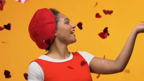 Happy Young Woman Standing Confetti Rain on Yellow Background, Romantic Mood