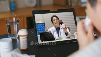  doctor about  fever illness while staying at home. Close up of patient about illness in video conferencing with general practitioner on digital tablet.