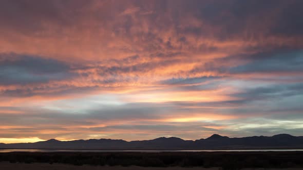 Time lapse viewing wave of color moving through the clouds