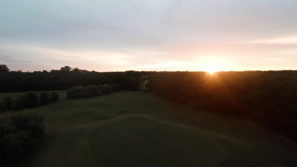 Tranquil aerial view of a golf couse at sunset