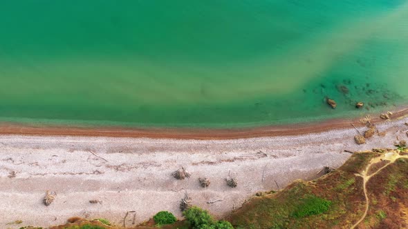 Aerial Drone Top Down View of Tropical White Beach Blue and Green Seaocean Rocks