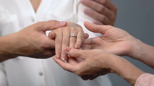 Loving Couple Showing Engagement Ring on Girlfriends Finger to Mother, Marriage