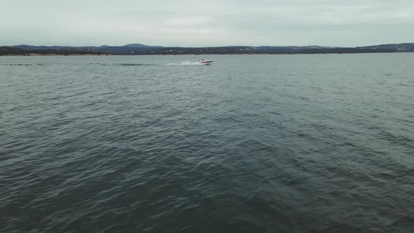  Boat with People Fast Drive Over Folsom Lake, CA