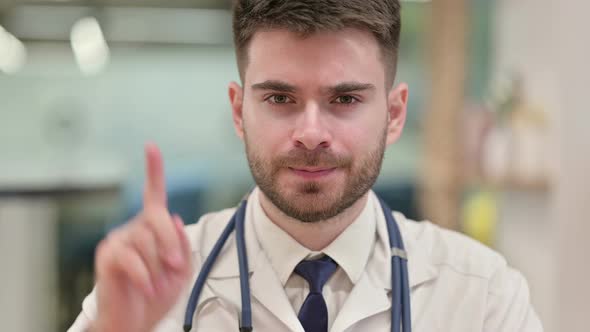 Cautious Doctor Saying No with Finger Sign 