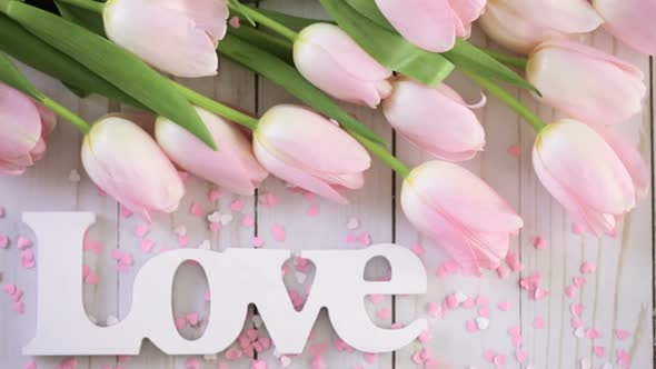 Bouquet of pink tulips on a wood background