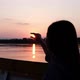 Slow motion of a female traveler playing and touching the sun while sailing a long tail boa - VideoHive Item for Sale