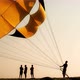 Silhouettes of people on the beach, They inflate the parachute - VideoHive Item for Sale
