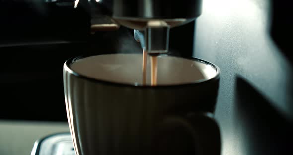 Pouring Coffee Stream From Machine in Cup