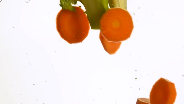 Washing broccoli and sliced carrots in water