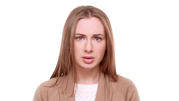 Surprised Beautiful Caucasian Female Standing in Amuzement on White Background in Slowmotion