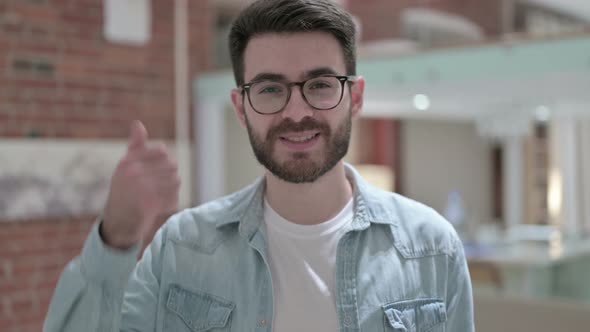 Portrait of Young Male Designer Showing Thumbs Up