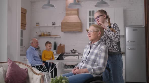 Caring Granddaughter Combing Disabled Grandmother