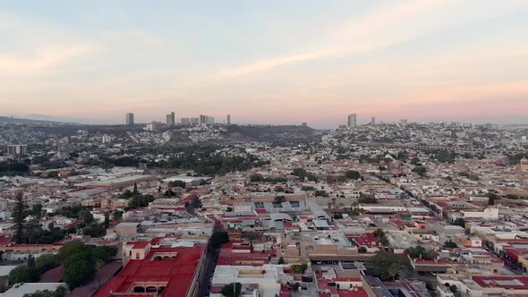 Flying Over Residential Houses From Mirador de Los Arcos At Dusk In Queretaro, Mexico. - aerial sout