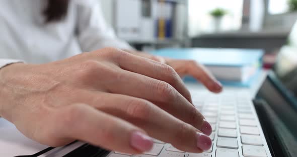 Female Hands Typing on Keyboard in Office Closeup