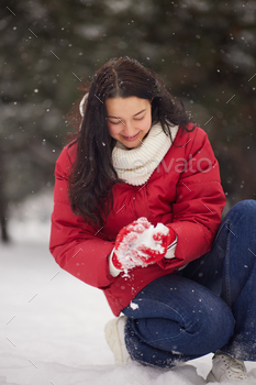 ing happy having fun outside on snowing winter day. Beautiful joyful multicultural Asian Caucasian girl outdoors.