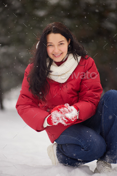 ng at camera smiling happy having fun outside on snowing winter day. Beautiful joyful multicultural Asian Caucasian girl outdoors.
