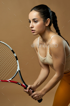 ooking away with serious expression. Isolated on beige background