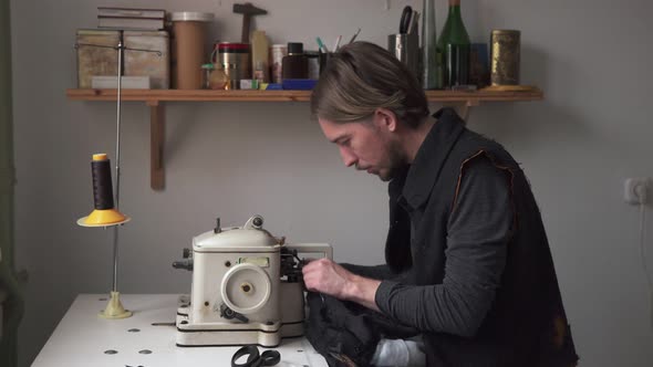 Male Tailor Sewing Fur on Furrier Machine in Workshop