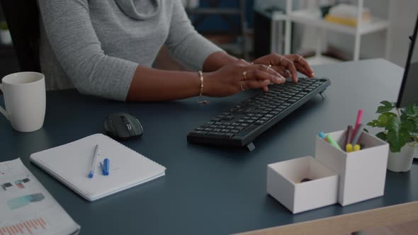 Closeup of Student with Black Skin Hands Typing on Keyboard Searching Information