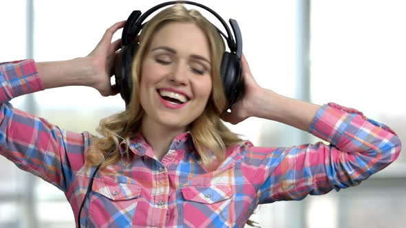 Beautiful Young Woman in Headphones Listening To Music