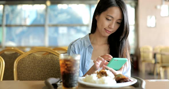 Woman sending sms on cellphone