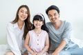 Portrait of Asian happy family smile and look at camera on bed at home. - PhotoDune Item for Sale