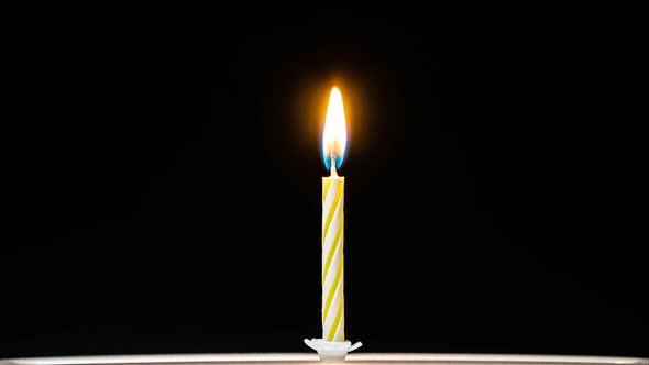 Birthday candle burning in timelapse alt