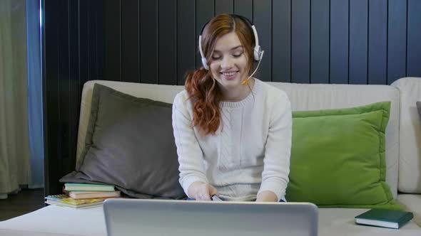 Young Smiling Student Wearing Headphones Communicating By Video Call Doing Distant Chat