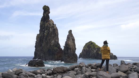 Woman looking at Ribeira da Janela islet in Madeira