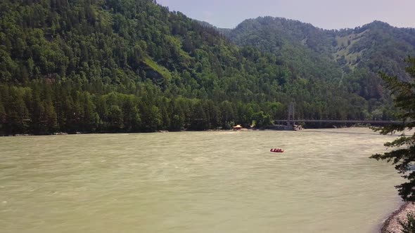 Aerial: Flying Over Mountain River. Also Visible: Coniferous Forest, Rapids on the River, Bank of