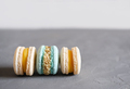 macaroons in pastel blue and beige colors on grey background. french sweet dessert - PhotoDune Item for Sale