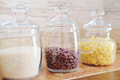 glass jars for food storage on a kitchen shelf. pasta, rice and beans in transparent containers - PhotoDune Item for Sale