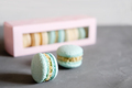 french macaroons in a pastel blue color and set of macarons in paper box on a background. copy space - PhotoDune Item for Sale