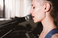 young female rock singer with microphone, singing. side view. close up. woman with short hair - PhotoDune Item for Sale