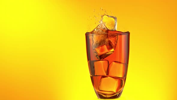 Super Slow Motion Shot of Ice Cubes Falling Into Glass of Ice Tea and Making Splash at 1000 Fps