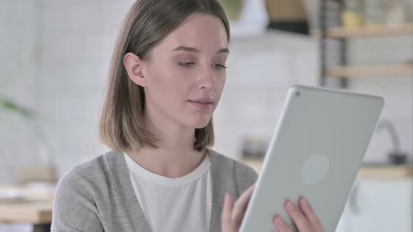 Portrait of Young Woman Using Tablet in Modern Office