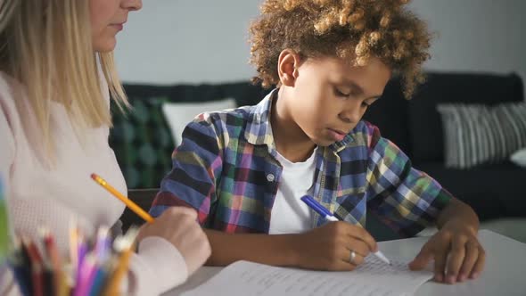 Happy Family Is Doing Homework at House with Living Room Background