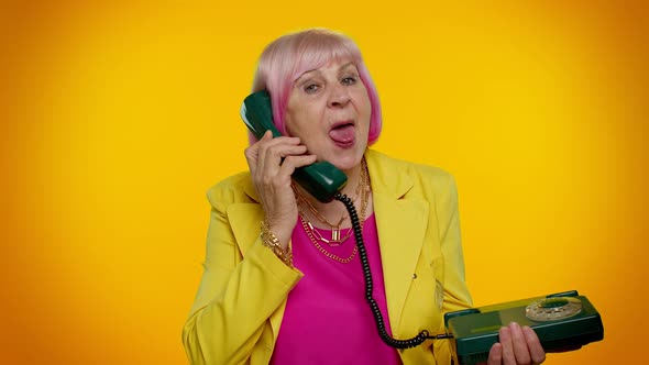 Crazy Elderly Granny Old Woman Talking on Wired Vintage Telephone of 80s Fooling Making Silly Faces