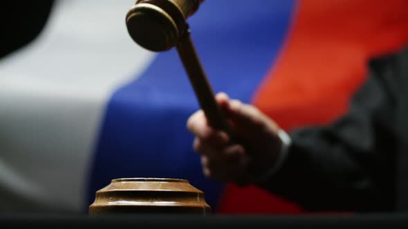 Judge With Gavel In His Hand Against Waving Russian Flag In Court Room