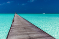 Jetty over atoll and a tropical resort island in Maldives - PhotoDune Item for Sale