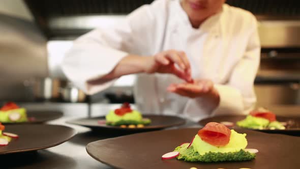 Smiling chef finalizing dishes