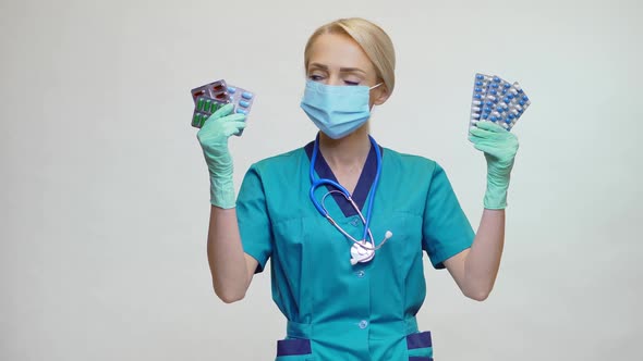 Medical Doctor Nurse Woman Wearing Protective Mask and Rubber or Latex Gloves - Holding Pills